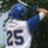 Pixelated image of a person in a blue and white sports uniform with the number 25, raising an arm against a dark green background.