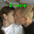 Two people kiss in a pixelated image with green text overlays reading "I love" and "Ashley Fijal" at the top, and "2.13.08 <3" below.