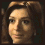 Four pixelated facial expressions of a person with brown hair against dark background