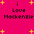 A static pixel art image with a bright pink background, yellow starbursts, and black text reading "i Love Mackenzie" repeated twice.