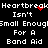 Black background with white pixelated text repeating 'Heartbreak Isn't Small Enough For A Band Aid' and red heart-shaped pixels in the center.