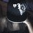 Animated icon shows a person in dark clothing with silver accents, transitioning from heart-shaped eyes to visible text on the chest.