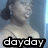 A pixelated image of a person with dark hair in a ponytail wearing a light-colored top, with text overlays changing across frames.