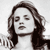 Static grayscale pixel art of a woman's face with long wavy hair, closed eyes, and neutral expression on a transparent background.
