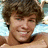 Pixelated portrait of a smiling person with brown hair on left, pink background with text "Mrs.", "Ryan", and "Sheckler" in black pixel font.