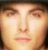 Pixelated close-up of a human face with light skin tone, brown eyebrows, and closed eyes under warm lighting.