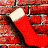 Red Christmas stocking with white cuff hangs on brick wall; lower section shows interior view of fireplace and purple flower.