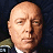 A 48x48 pixel buddy icon split into two sections: a grayscale portrait of a bald man on the left and green text reading "Original Icons .com" on a dark green background on the right.