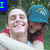 Two people embrace outdoors; one wears a blue cap with yellow text, the other has long dark hair. Text overlays change across frames.