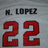 Pixelated image showing 'M. LOPEZ' text above large red '22' numerals on a gray background.