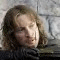 A sequence of animated frames showing a person with long brown hair against a stone wall background, with text overlays changing across frames.