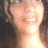 A pixelated close-up of a person's face with a bright light source causing overexposure, showing partial facial features and a blurred background.