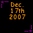 Black background with orange text reading "Dec. 17th 2007" and purple star-shaped elements in various positions.