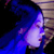 A pixelated image shows a glowing white and purple figure with blue smoke-like effects against a dark background.
