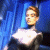 Pixelated image of a person with light brown hair in profile against blue background, next to green text reading Original Icons .com.