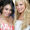 Two women pose closely together; one wears a red and white patterned dress, the other a white strapless top, both smiling at the camera.
