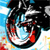 Pixelated circular icon with black, white, red, and blue tones showing a stylized face with closed eyes and a wide open mouth against a light blue background.