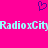 A static pixel art image with a bright pink background, light blue text reading "RadioxCity" repeated twice horizontally, and a small purple heart symbol above the text.