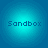 Four identical cyan circular icons with pixelated 'Sandbox' text centered on a blue background.