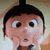 Pixelated cartoon character with black hair, large eyes, and a surprised expression, wearing a dark blue shirt with a brown collar.