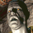 Pixelated image of a mummy-like figure with bandaged head and face, next to fiery 'DOOM 3' text on black background.