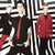 Pixelated image of three figures in front of a maze-like background with 'GREEN DAY' text above and partial red text below.