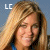 Pixelated static image of a person with long light brown hair and closed eyes, wearing glasses and a blue top against a gradient background with "LC" text in the corner.