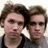 Two identical young men with brown hair stand side-by-side in a static image, with a blue text below them reading "Ph... Who needs Edward Cullen when there's Brandon Urie?"