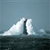 Pixelated static image of a sailboat with white sails and a dark mast on a blue-gray sea under a light blue sky.
