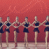 Six identical figures in dark blue outfits stand side-by-side against a red background, holding hands with arms extended horizontally.
