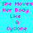 Pixelated text on cyan background with yellow highlight bars, displaying "She Moves Her Body Like A Cyclone" in pink letters.