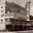 Static grayscale image of a building facade with vertical columns and horizontal architectural details, partially obscured by pixelation.