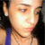 Pixelated close-up of a person with light skin tone, dark hair, and a blue strap visible on the left shoulder.