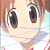 Anime-style character face with brown hair and large brown eyes, wearing a white shirt with red trim under light blue background.