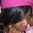 A person with dark hair and a pink headband appears in a of four , with the bottom-right empty