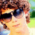 A pixelated image of a person with brown curly hair and dark sunglasses, showing four variations where text overlays change sequentially.