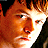 A 48x48 pixel buddy icon featuring a split composition with a person's face on the left, a remote control on the right, and text "AWAY FROM THE SUN" below in white block letters against black background.