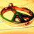 A pixelated circular icon with a green and brown pattern on a yellow background, next to a solid bright green rectangle.