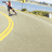Animated sequence of a person in red and white athletic gear performing rollerblading moves on a paved road with yellow lane markings.