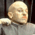 A pixelated contact sheet showing two frames of an animated icon featuring a bald character in gray clothing on the left and green text reading "Original Icons .com" on the right against a dark background.