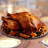 Static image of roasted turkey with golden-brown skin on a plate, garnished with green herbs against warm-toned background.