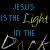 Animated text repeats 'JESUS IS THE Light IN THE Dark' with color variations on a black background, showing sequential changes in letter colors.