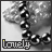A grayscale image of a beaded necklace with the word 'lovely' in lowercase text below it, showing subtle color variations