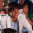 Two people in white shirts embrace against a blurred background, with pink pixelated text on cyan right side.