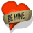 Red heart-shaped icon with beige banner reading 'BE MINE' across middle, displayed in