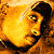 A 2x2 contact sheet of a pixelated Tupac Shakur image with text elements, showing different frames from an animated icon.