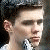 Four- of pixelated character faces with green text overlays, showing facial expression changes and partial text variations