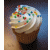 Pixelated cupcake with white frosting and multicolored sprinkles, next to orange text reading 'cupcakes cannot change the world' and a skull-and-crossbones symbol.