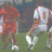Pixelated image of two soccer players on a field with orange text displaying 'R.I.P. Mr. Sze #8' and dates 'Oct. 10 1929 - Aug. 23 2005'