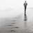 A grayscale image shows a tall, thin structure on a reflective surface with text reading 'My image of you is fading...' in pixelated font.